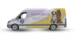 A picture of a mobile grooming van with the groombar logo on the side