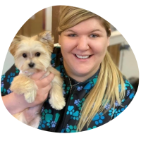 a picture of Megan Rozell, blonde woman holding a white dog